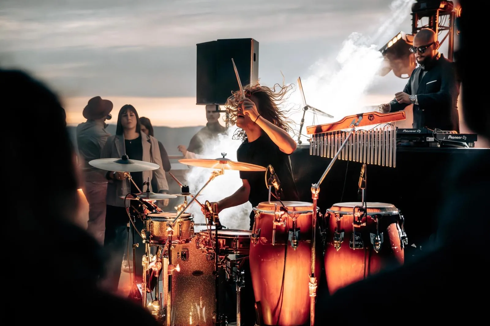Cyrille, percussionist in the network, on the drums facing the sunset during a set